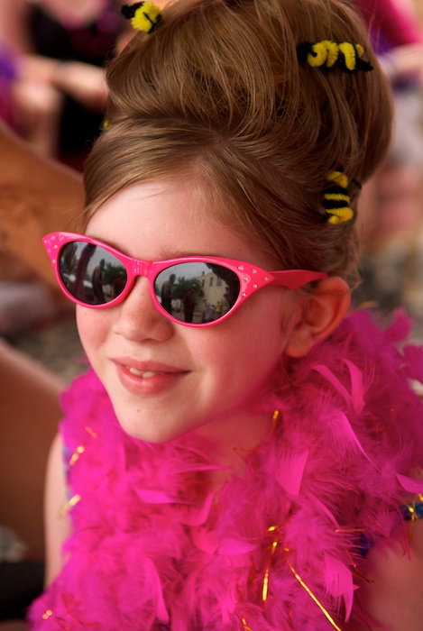 A young girl sports a beehive hairdo complete with pipe-cleaner bees.